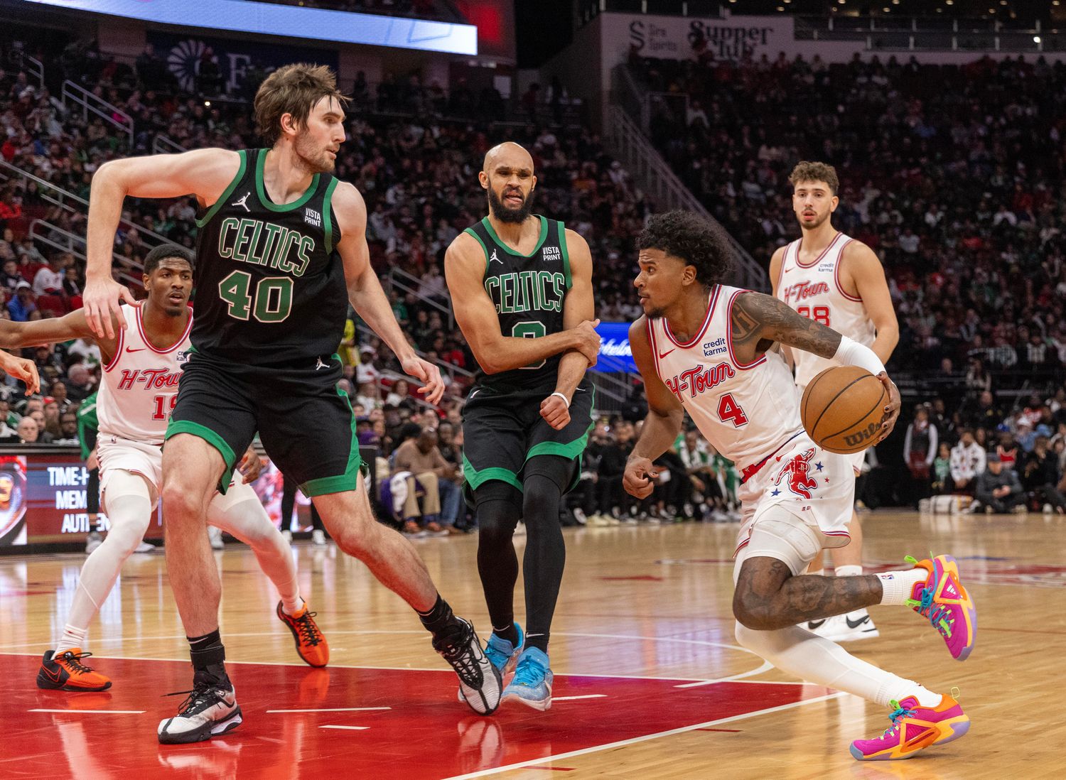 Rockets guard Jalen Green drives to the net against Boston Celtics center Luke Kornet (40) in the second quarter at Toyota Center.